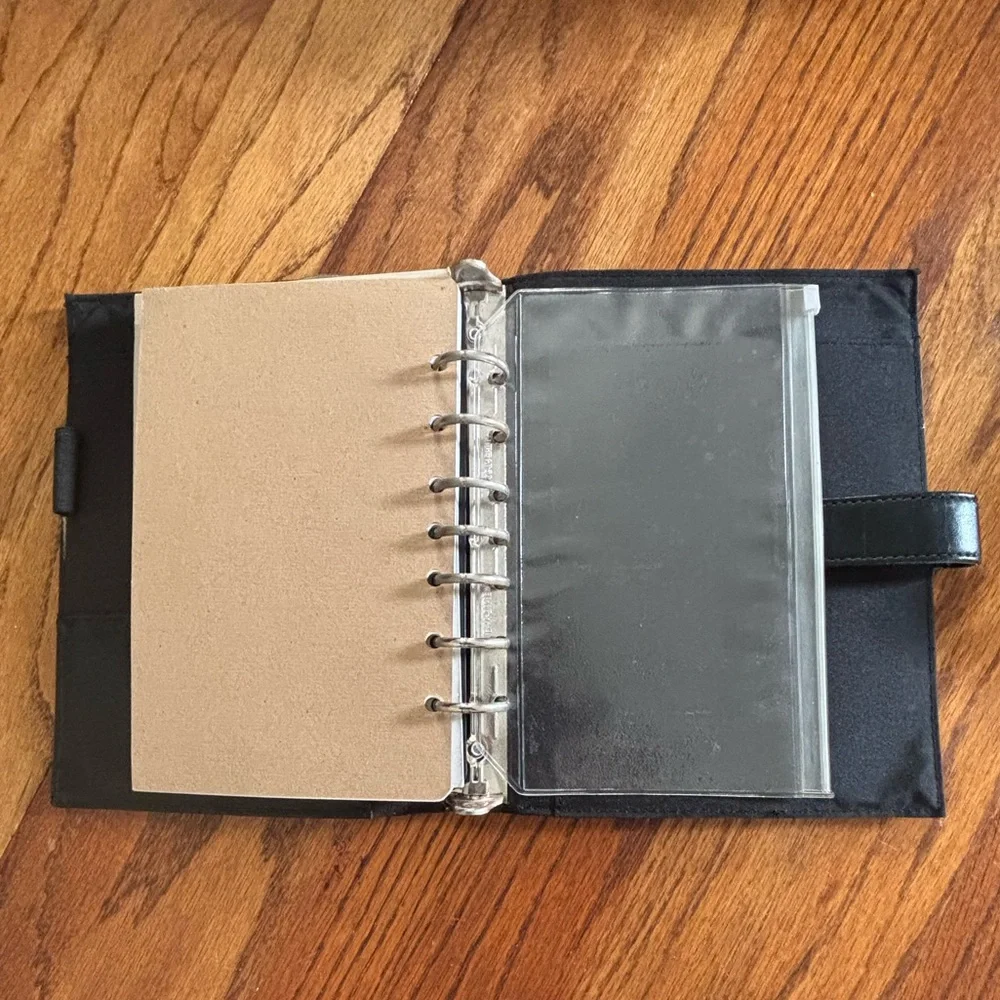 Black Leather (?) Day Timer Planner with Extra pages.